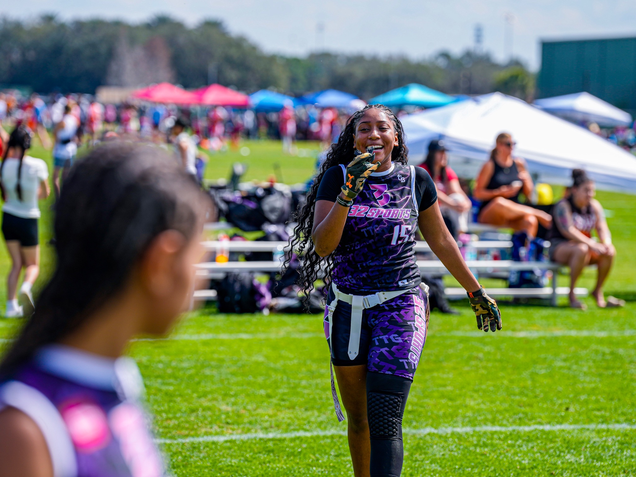Smiling 32 Sports flag football player wearing number 15 on the field