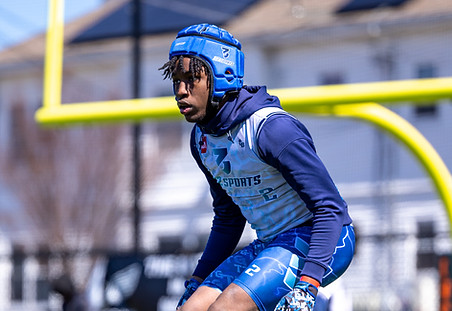 32 Sports athlete in a blue uniform and padded helmet preparing for a play