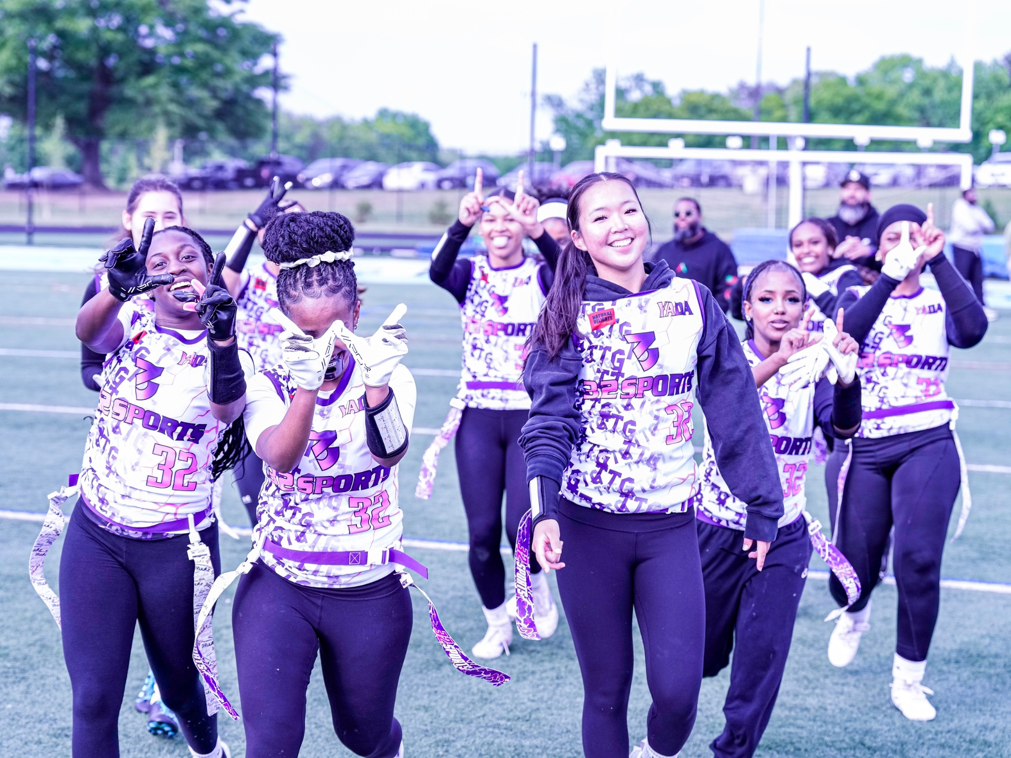 32 Sports girls flag football teammates celebrating together