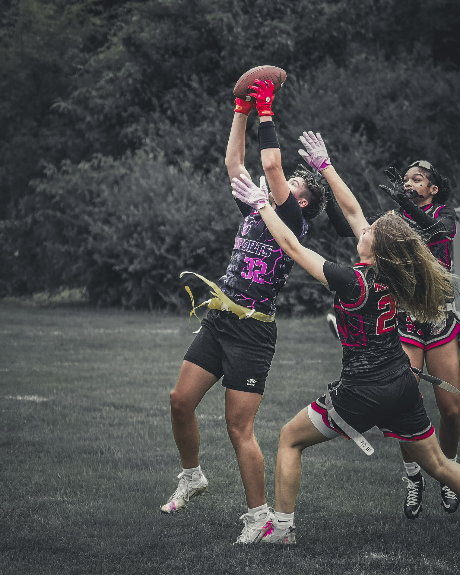 32 Sports receiver reaching above defenders to catch a football
